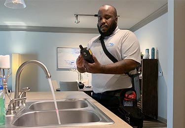 Rodney Ruffin, certified home inspector, checking the kitchen plumbing.